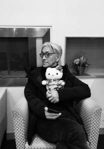 Holding a kitty doll in a hand