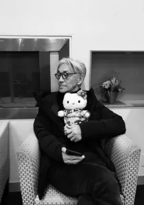 Holding a kitty doll in a hand